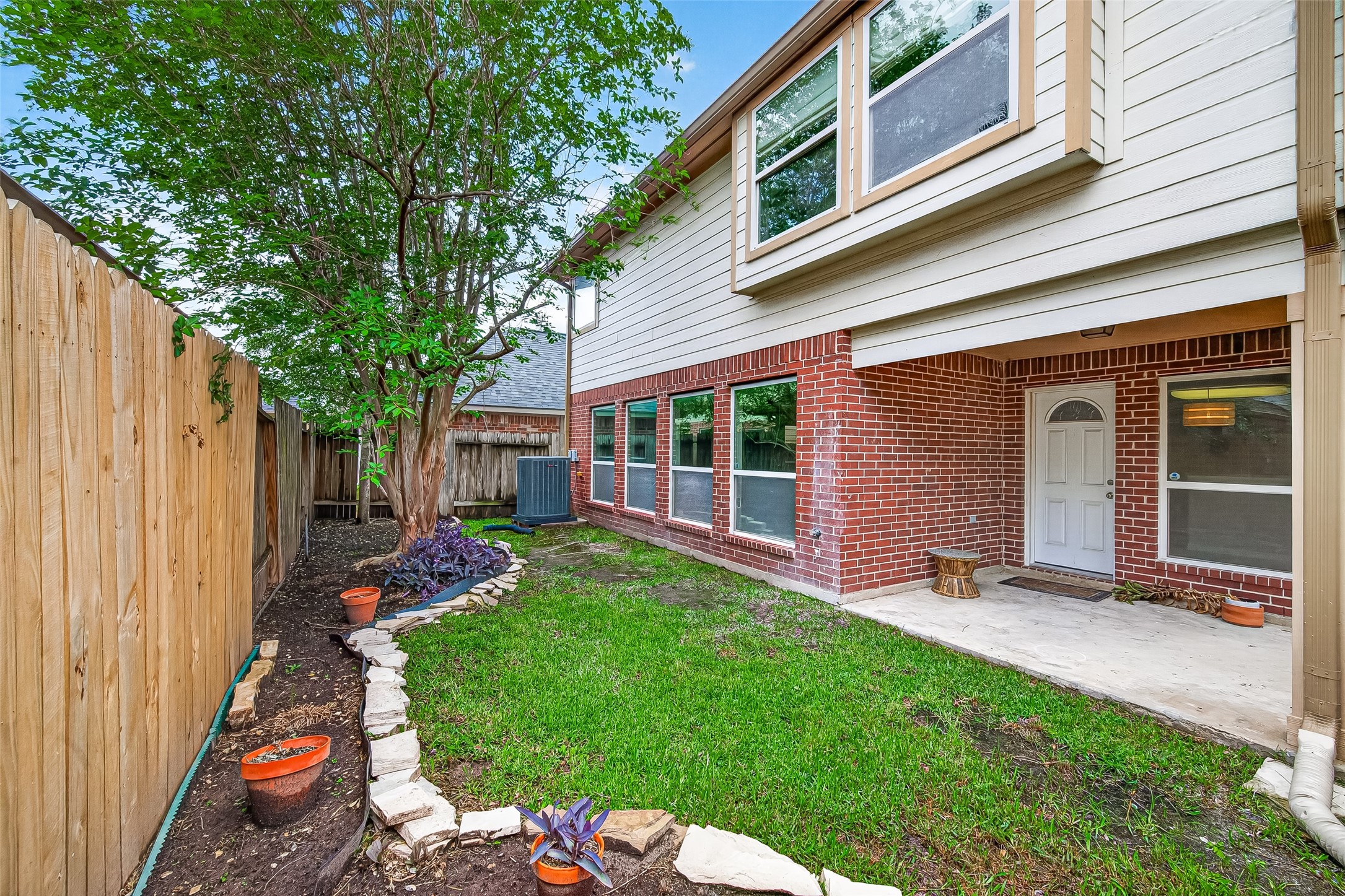2415 Lacyberry Street Houston, TX 77080 - Photo 47 of 50 a view of a backyard with table and chairs and a large tree