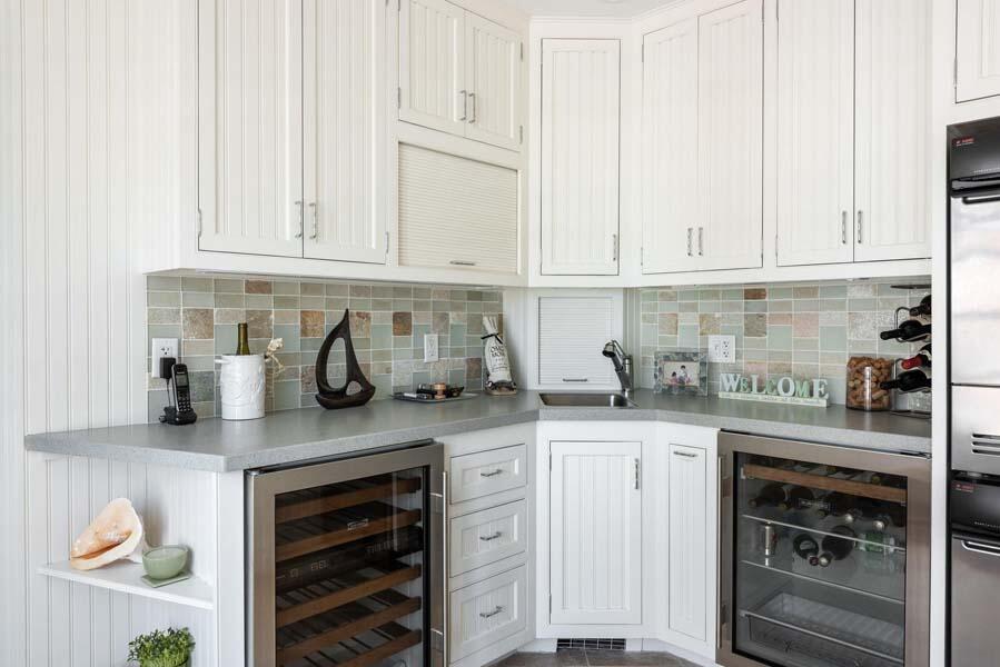 56 Rendezvous Lane Barnstable, MA 02630 - Photo 18 of 38 a kitchen with granite countertop white cabinets and stainless steel appliances