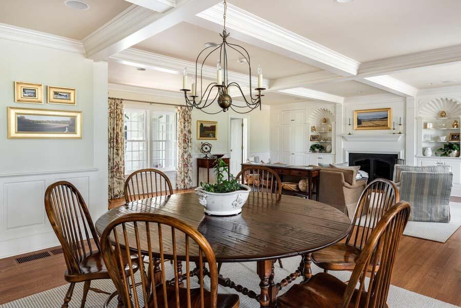 56 Rendezvous Lane Barnstable, MA 02630 - Photo 19 of 38 a view of a dining room with furniture a chandelier and wooden floor