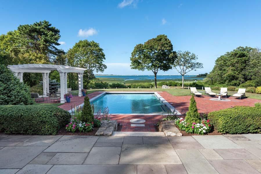 56 Rendezvous Lane Barnstable, MA 02630 - Photo 2 of 38 a backyard of a house with lots of green space and fountain