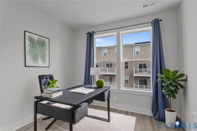 a view of a workspace with furniture and a potted plant