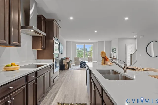 a kitchen with stainless steel appliances a sink a stove and a refrigerator