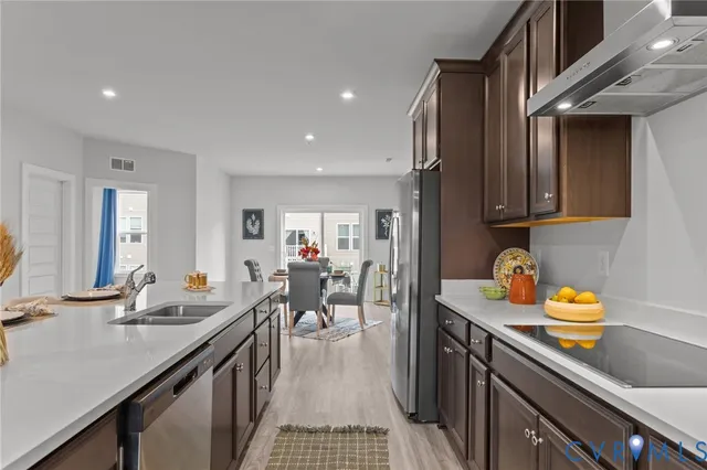 a kitchen with lots of counter top space and view of living room