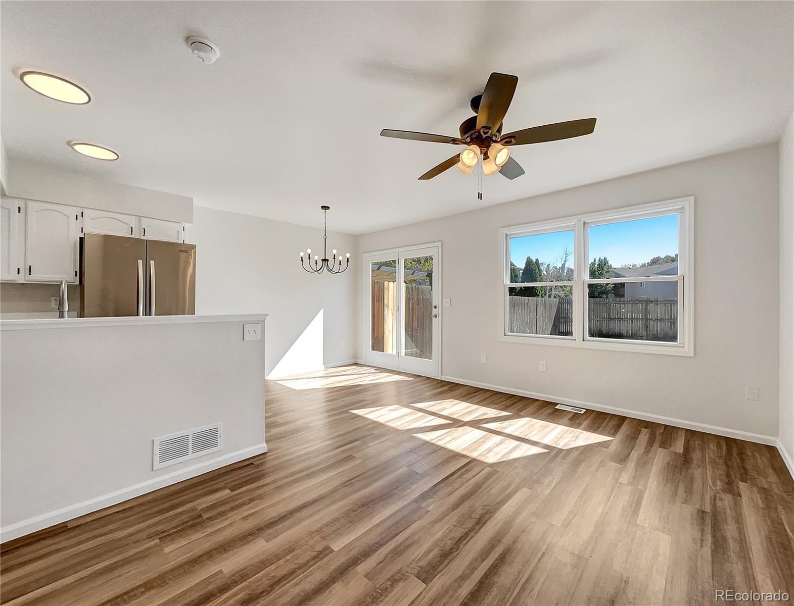 2134 3rd Street Southwest, Unit 2 Loveland, CO 80537 - Photo 11 of 31 a view of an empty room with window and wooden floor