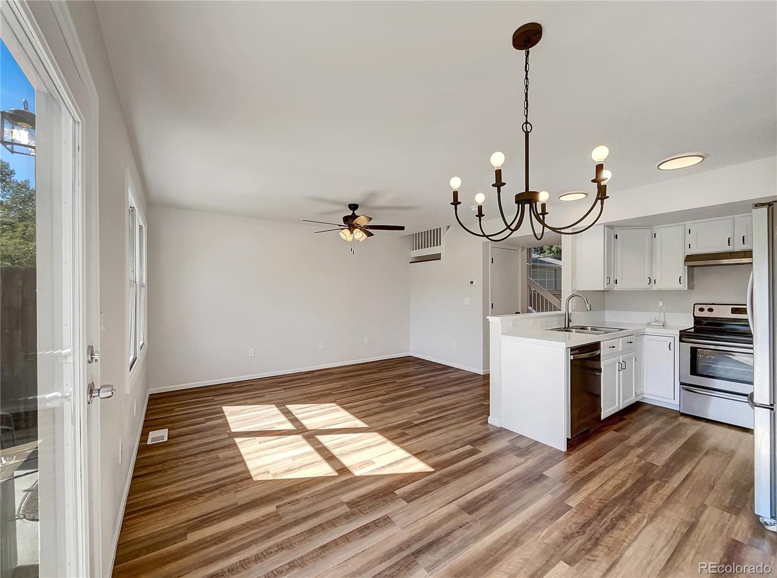 2134 3rd Street Southwest, Unit 2 Loveland, CO 80537 - Photo 12 of 31 a kitchen with white cabinets and stainless steel appliances