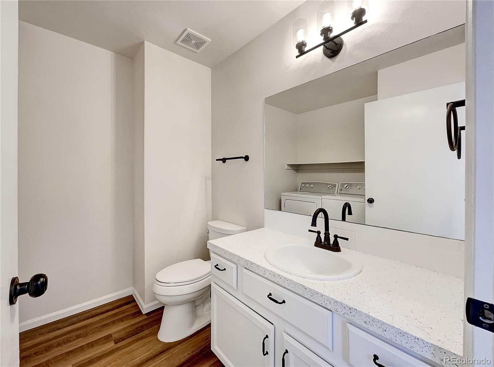 2134 3rd Street Southwest, Unit 2 Loveland, CO 80537 - Photo 15 of 31 a bathroom with a sink a toilet and a mirror