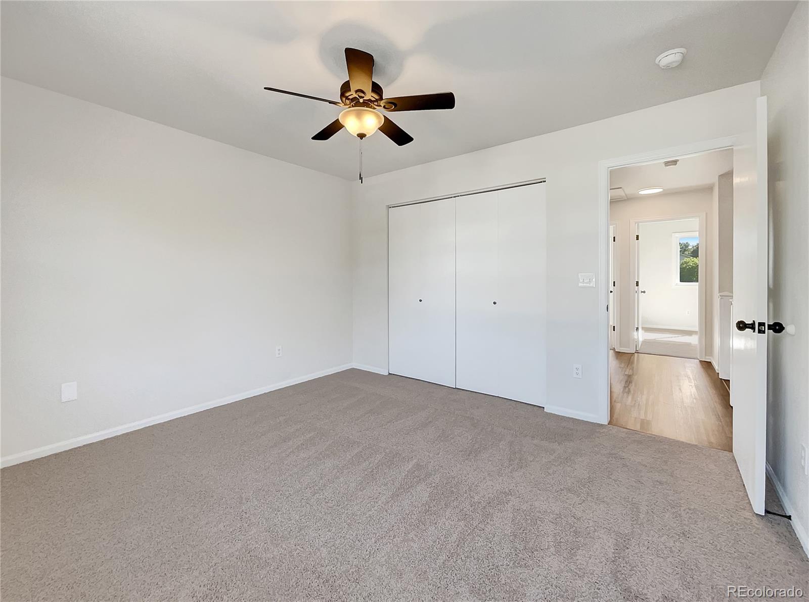 2134 3rd Street Southwest, Unit 2 Loveland, CO 80537 - Photo 17 of 31 a view of a livingroom with a chandelier fan and a kitchen