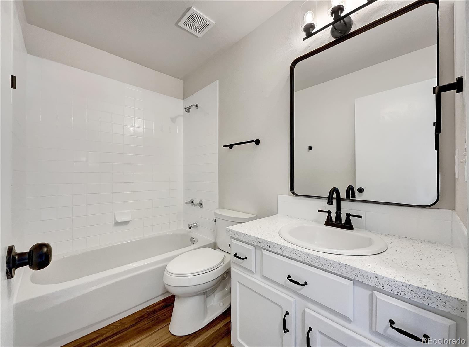 2134 3rd Street Southwest, Unit 2 Loveland, CO 80537 - Photo 19 of 31 a bathroom with a sink a toilet and a mirror