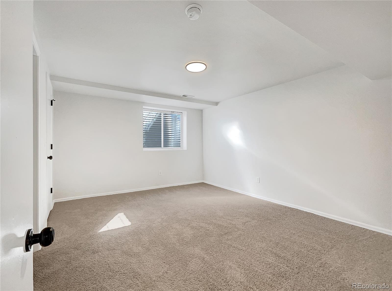 2134 3rd Street Southwest, Unit 2 Loveland, CO 80537 - Photo 23 of 31 a view of an empty room with a window