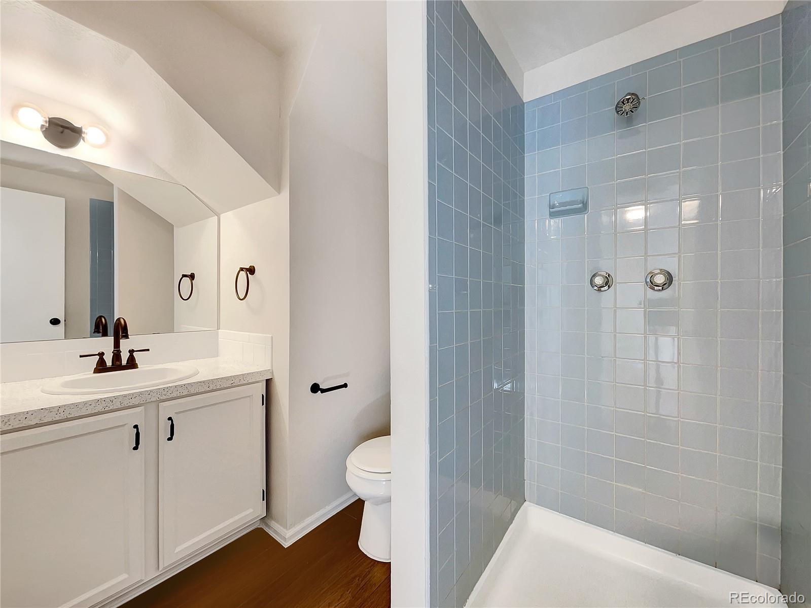 2134 3rd Street Southwest, Unit 2 Loveland, CO 80537 - Photo 25 of 31 a bathroom with a sink a toilet and shower