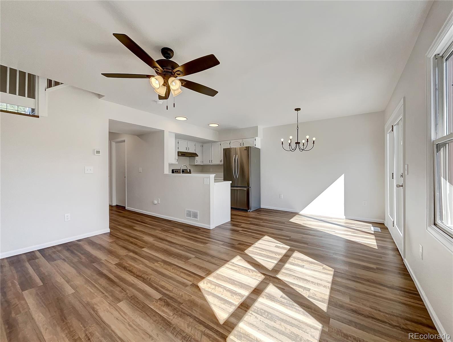 2134 3rd Street Southwest, Unit 2 Loveland, CO 80537 - Photo 4 of 31 a view of empty room with wooden floor and ceiling fan