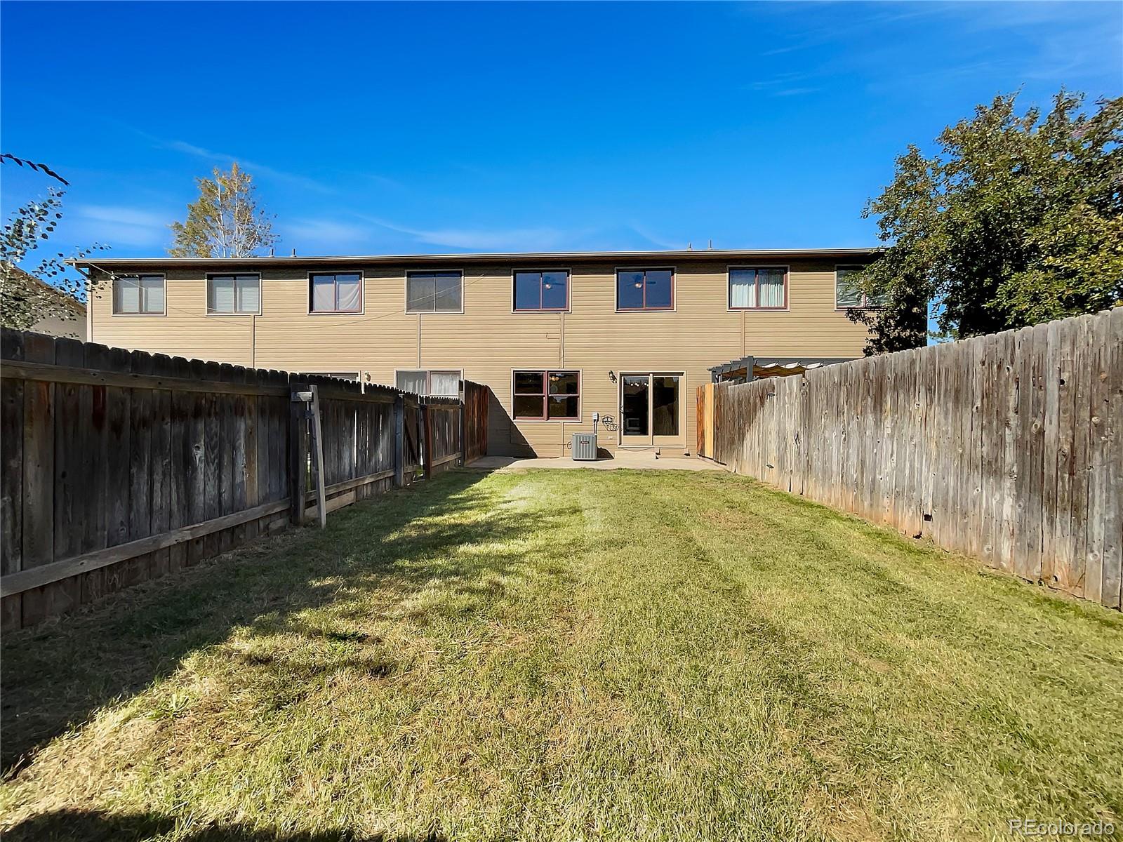 2134 3rd Street Southwest, Unit 2 Loveland, CO 80537 - Photo 5 of 31 a view of house with backyard and a patio