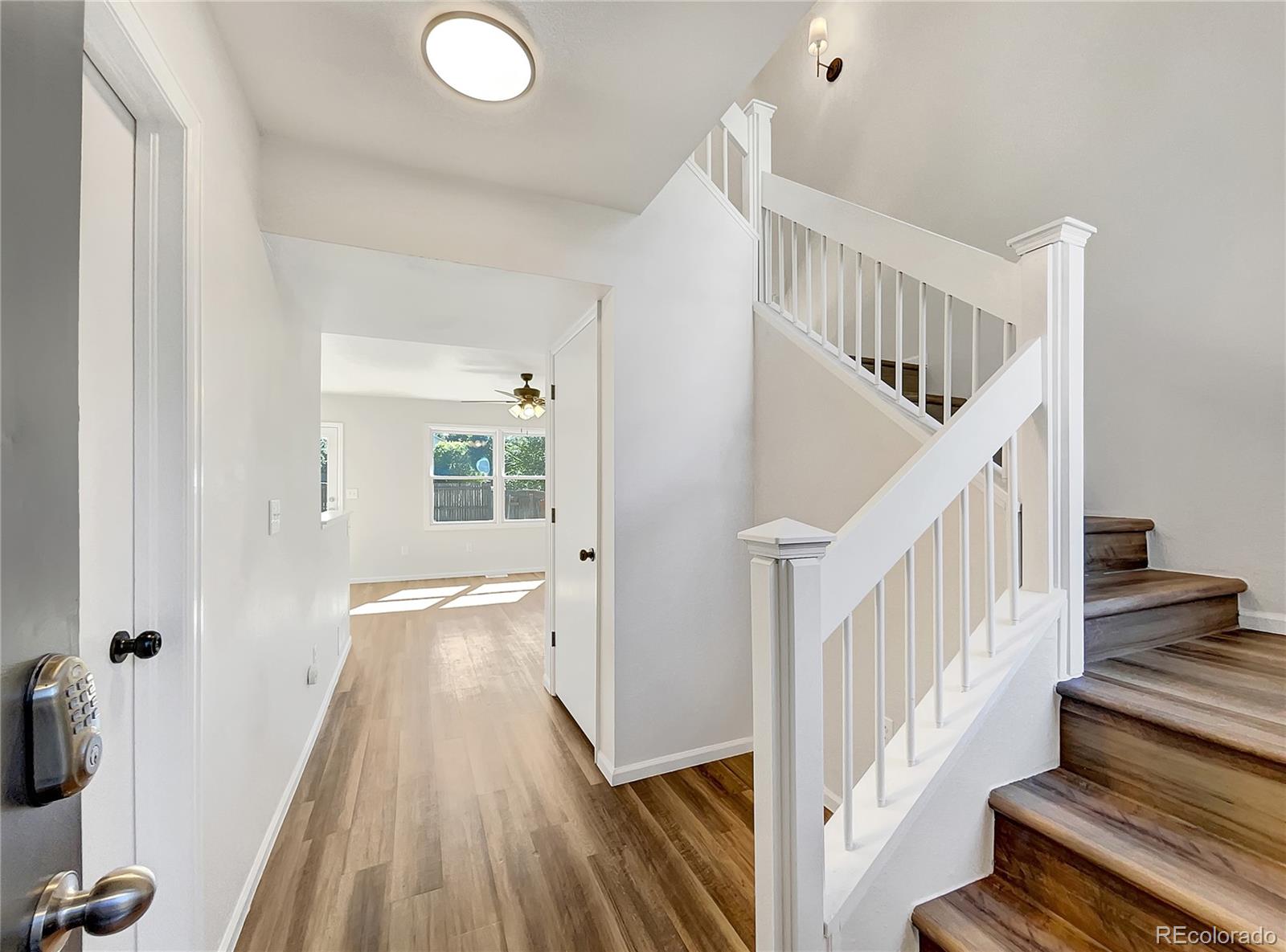 2134 3rd Street Southwest, Unit 2 Loveland, CO 80537 - Photo 8 of 31 a view of a hallway with wooden floor and staircase