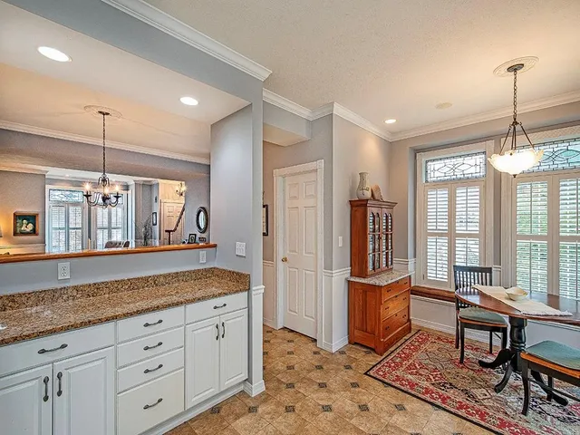 a spacious bathroom with a granite countertop sink a mirror and a shower