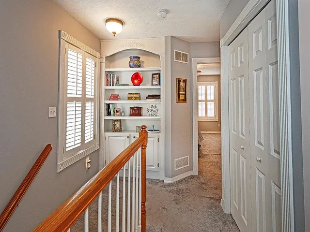 a view of hallway with window and furniture