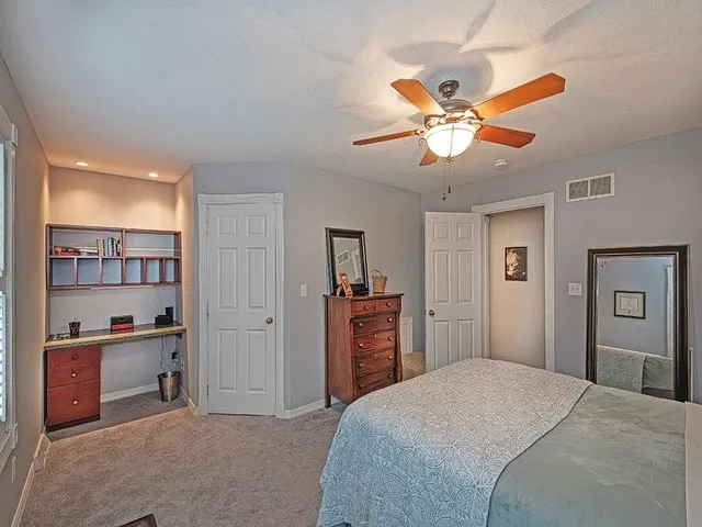 a living room with furniture a flat screen tv and a window