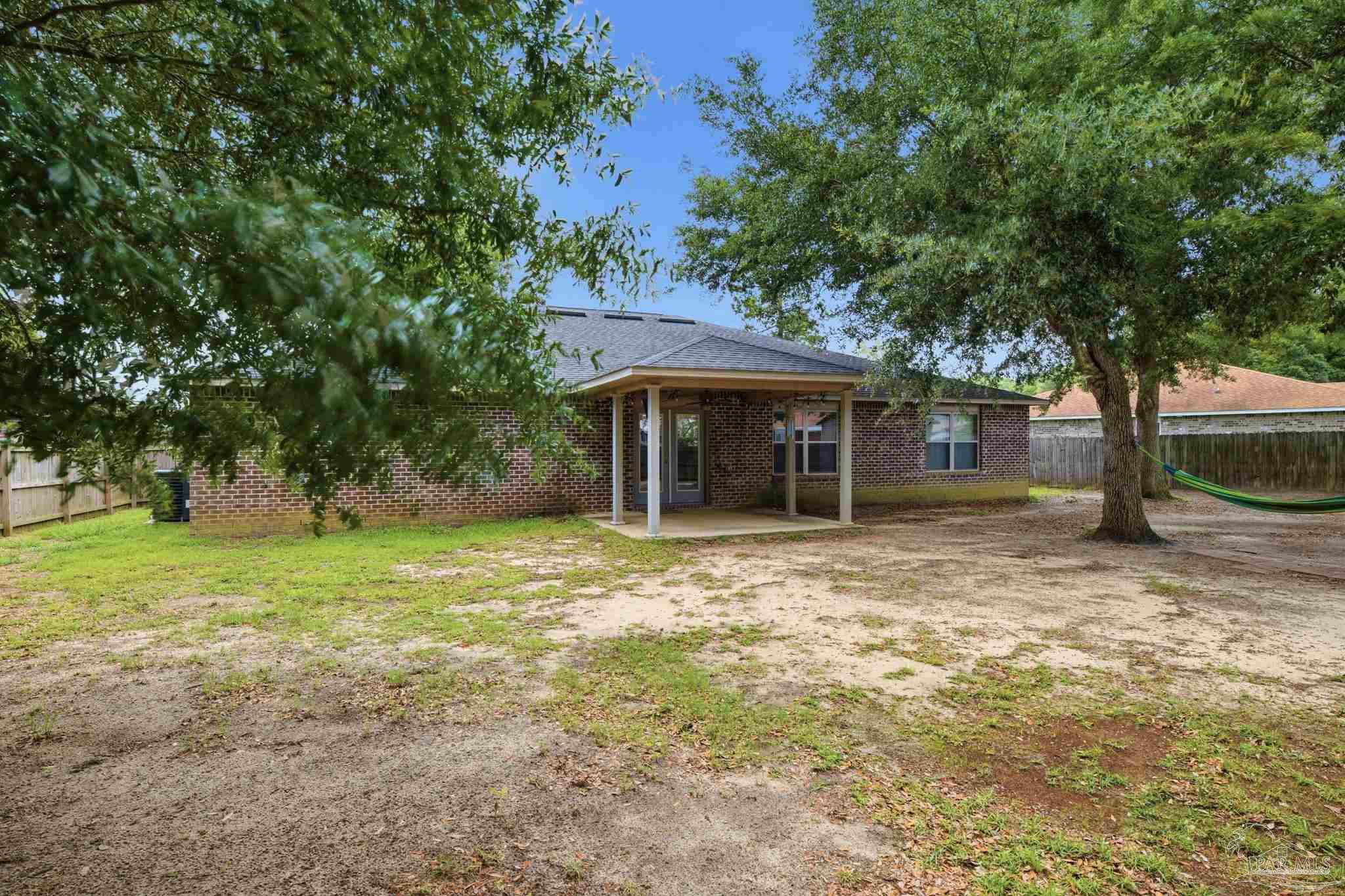 5661 Cane Syrup Circle Pace, FL 32571 - Photo 18 of 20 a view of a house with a yard