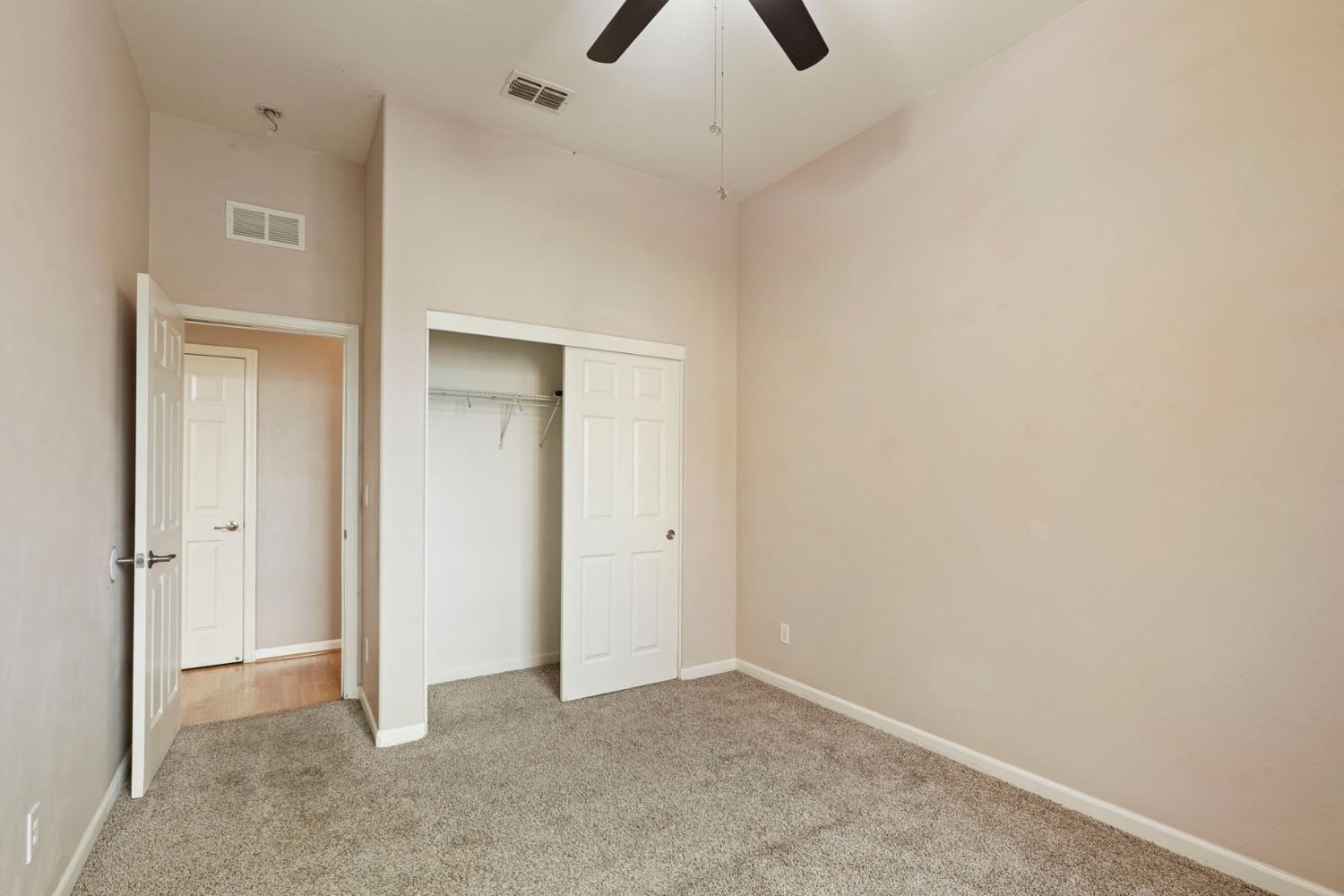 904 Sebastian Lane Manteca, CA 95336 - Photo 11 of 21 an empty room with closet and a chandelier fan