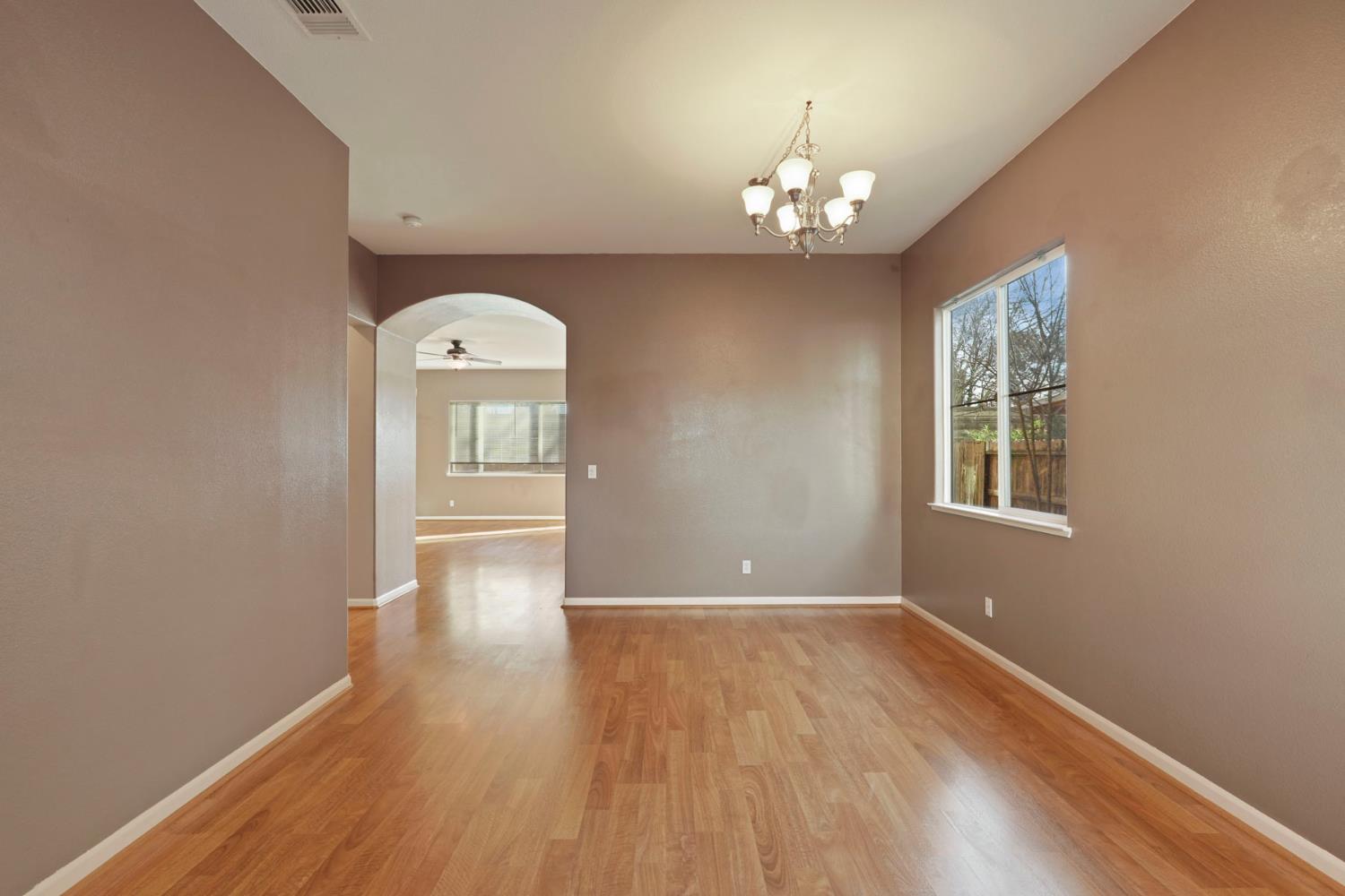 904 Sebastian Lane Manteca, CA 95336 - Photo 4 of 21 a view of a room with wooden floor chandelier and window