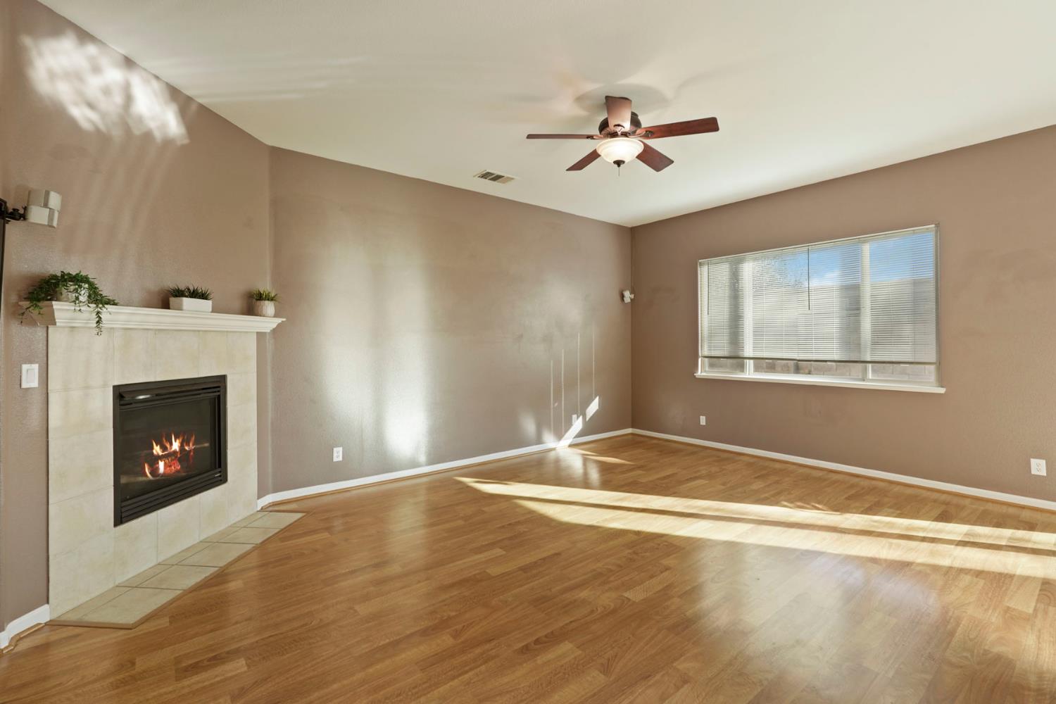 904 Sebastian Lane Manteca, CA 95336 - Photo 6 of 21 a view of an empty room with window and fireplace