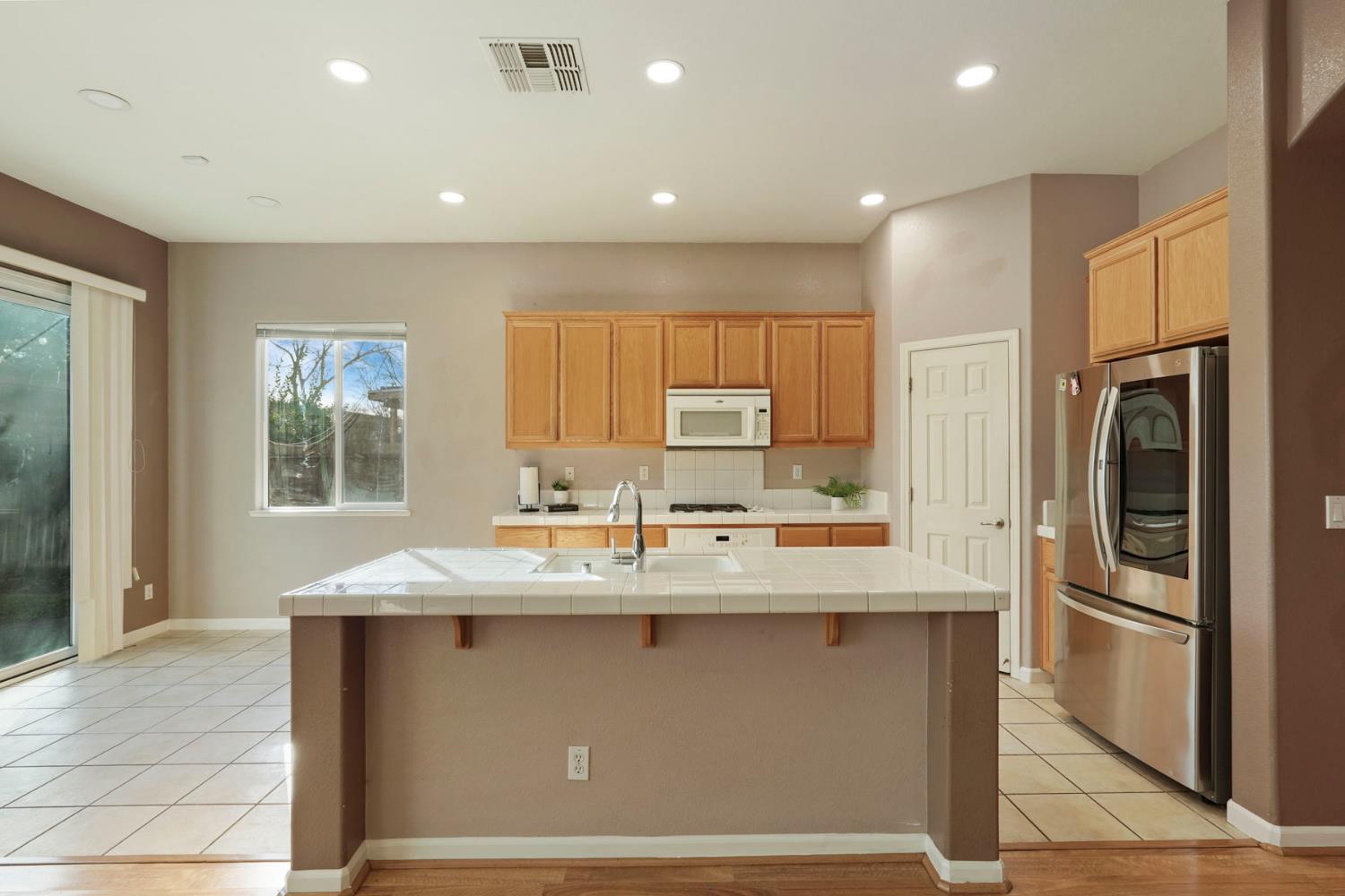 904 Sebastian Lane Manteca, CA 95336 - Photo 7 of 21 a kitchen with stainless steel appliances granite countertop a refrigerator a sink a stove and oven