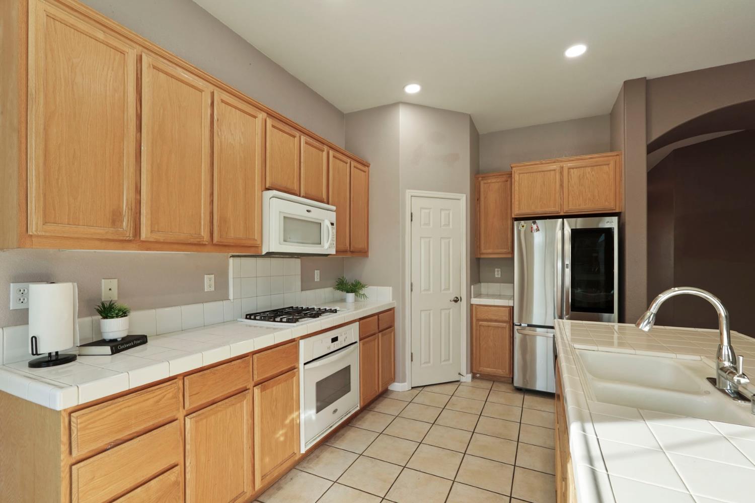 904 Sebastian Lane Manteca, CA 95336 - Photo 8 of 21 a kitchen with stainless steel appliances granite countertop a sink and a refrigerator