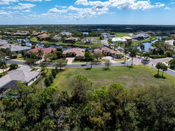 an aerial view of residential houses with outdoor space and ocean view