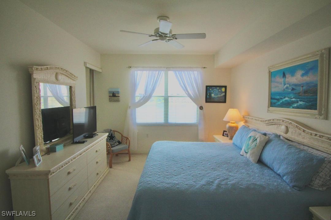 14061 Brant Point Circle, Unit 7304 Fort Myers, FL 33919 - Photo 11 of 49 a bedroom with a bed and a flat screen tv