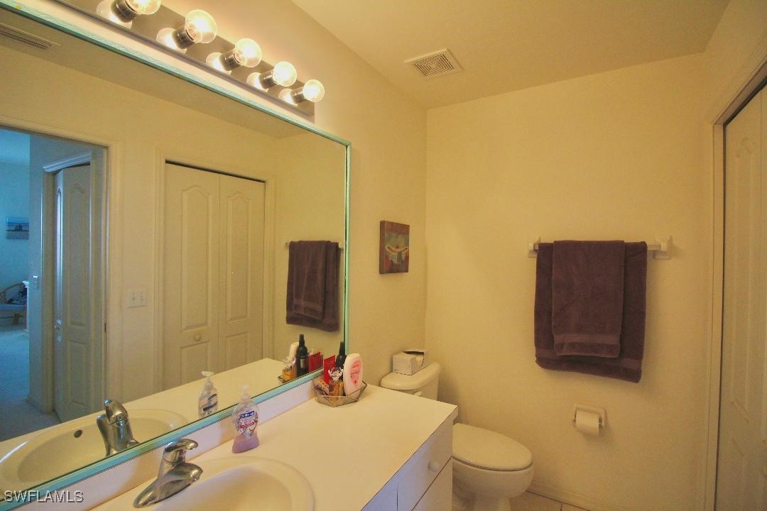14061 Brant Point Circle, Unit 7304 Fort Myers, FL 33919 - Photo 13 of 49 a bathroom with a granite countertop sink and a mirror