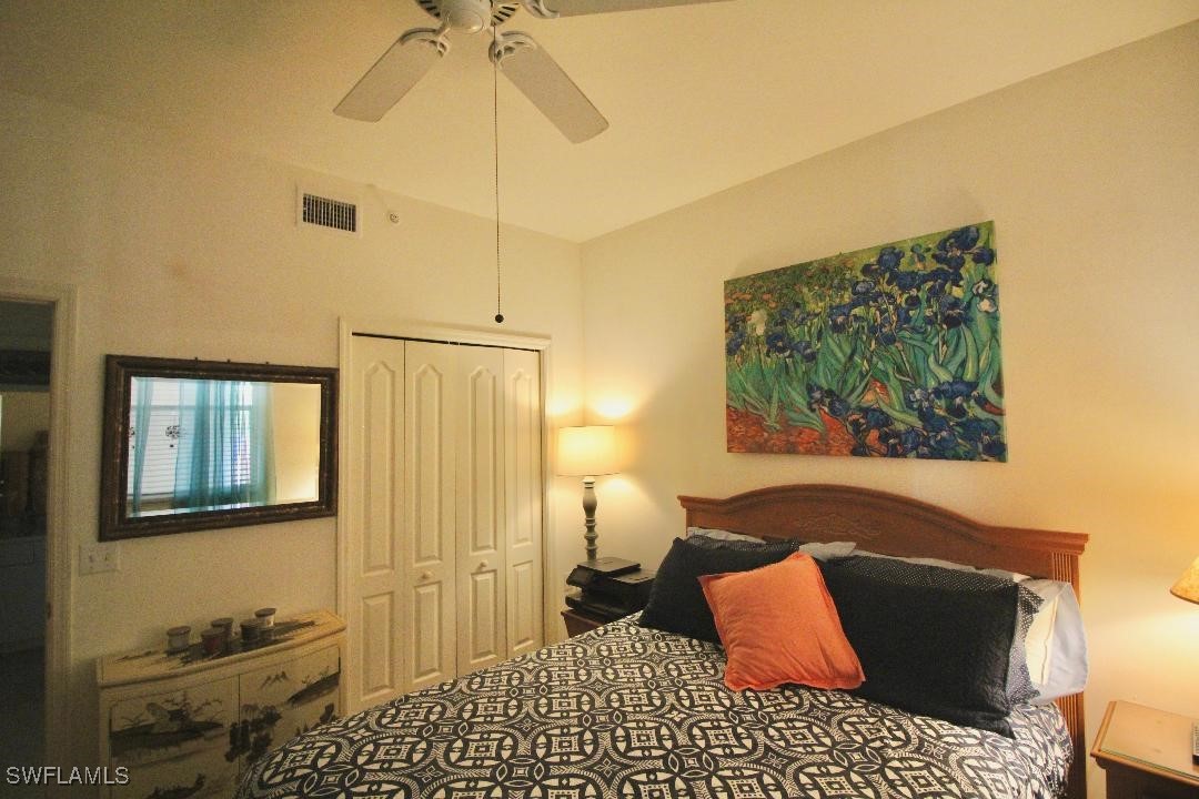 14061 Brant Point Circle, Unit 7304 Fort Myers, FL 33919 - Photo 18 of 49 a bedroom with a bed and a painting on the wall