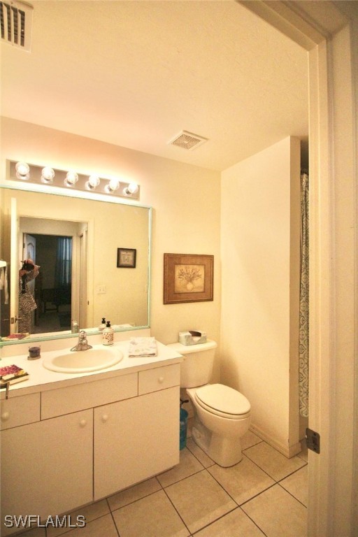 14061 Brant Point Circle, Unit 7304 Fort Myers, FL 33919 - Photo 21 of 49 a bathroom with a toilet sink and mirror