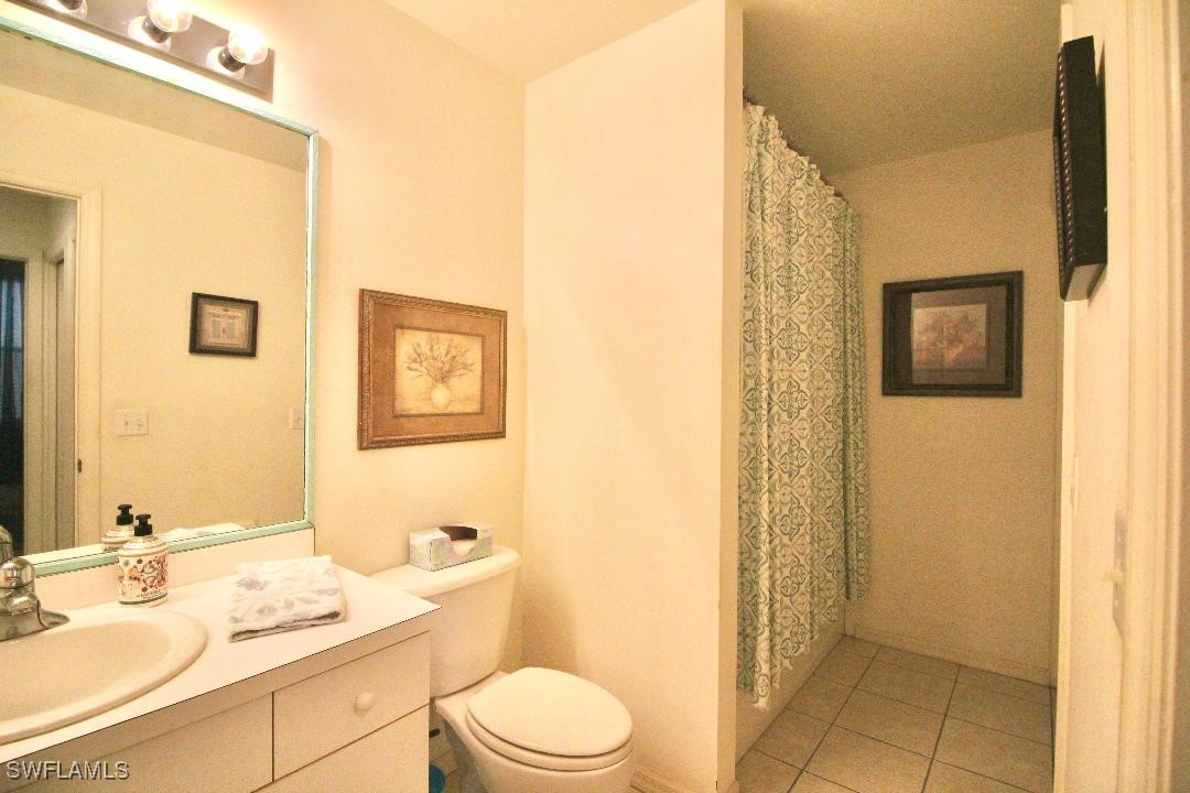 14061 Brant Point Circle, Unit 7304 Fort Myers, FL 33919 - Photo 23 of 49 a bathroom with a granite countertop sink toilet and shower