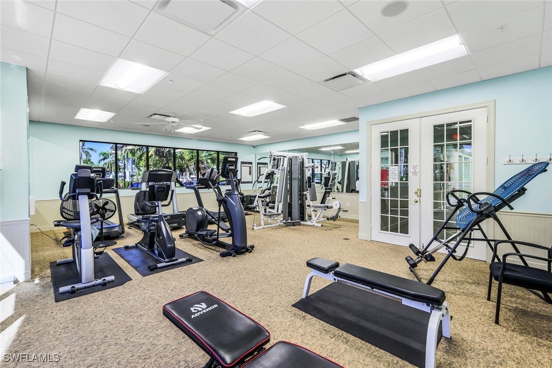 14061 Brant Point Circle, Unit 7304 Fort Myers, FL 33919 - Photo 46 of 49 a room with gym equipment and large mirror