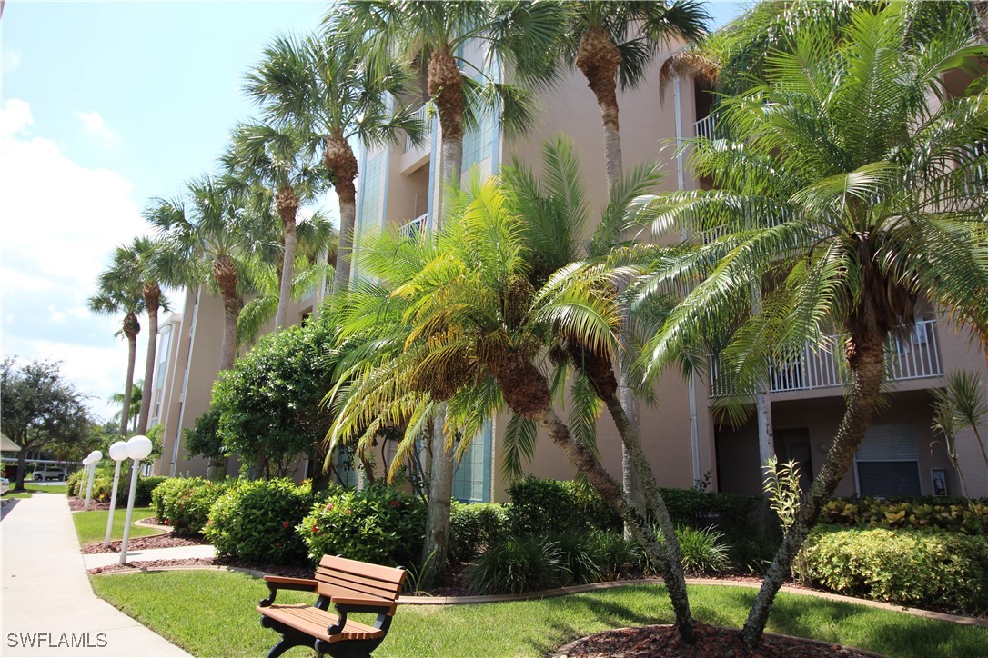 14061 Brant Point Circle, Unit 7304 Fort Myers, FL 33919 - Photo 8 of 49 a front view of a house with yard and green space