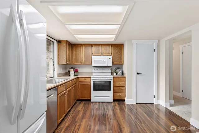 a kitchen with a refrigerator stove top oven and sink