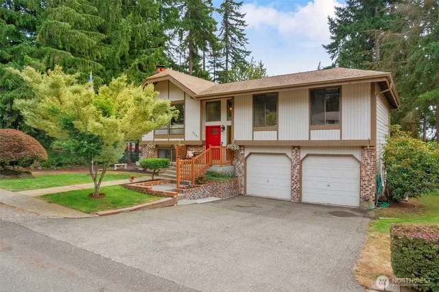 a view of house with outdoor space and parking