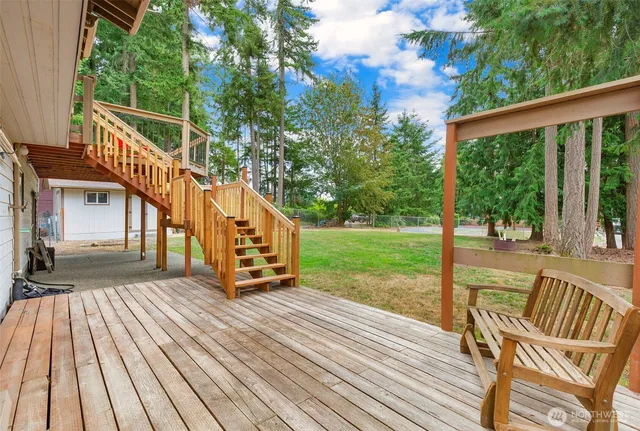 a view of a house with backyard and sitting area