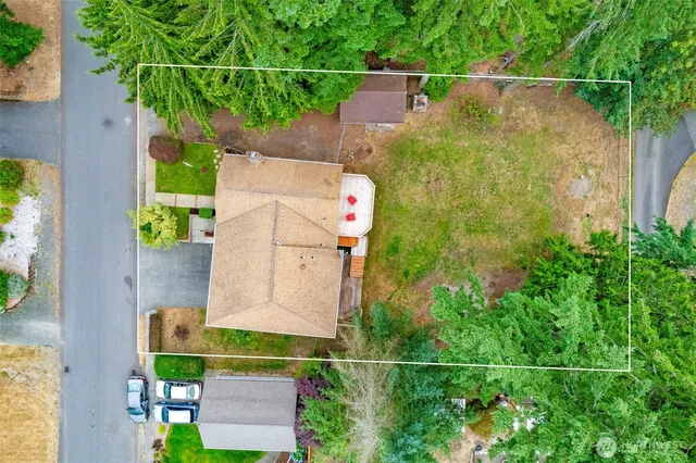 an aerial view of a house with a yard