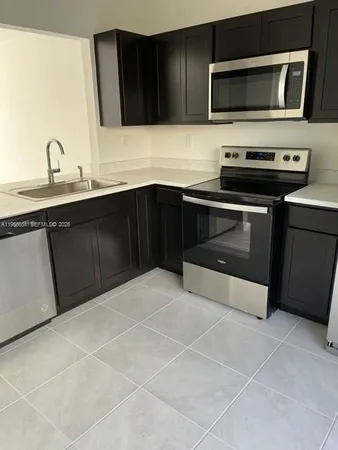 a kitchen with a stove and a microwave