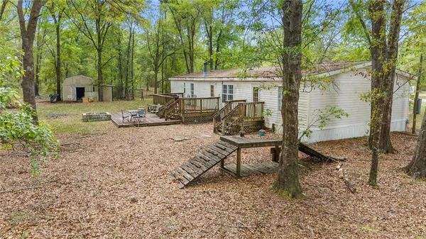 a view of a house with backyard and a tree