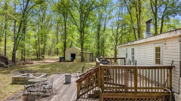 a view of a roof deck with wooden fence and floor