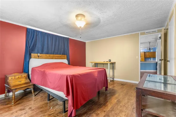 a bedroom with a bed and a mirror