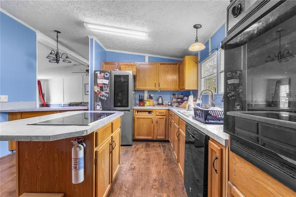 a kitchen with stainless steel appliances granite countertop a sink and cabinets