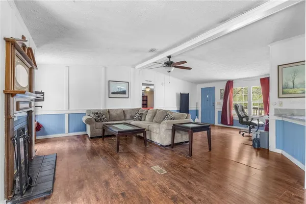 a living room with fireplace furniture and a flat screen tv