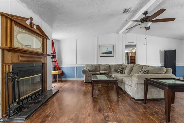 a living room with furniture a fireplace and a flat screen tv