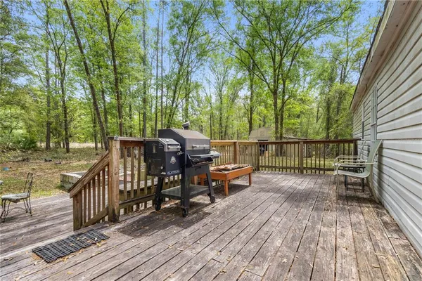 a view of a wooden deck with chairs