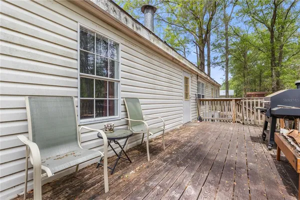 a roof deck with table and chairs and wooden floor