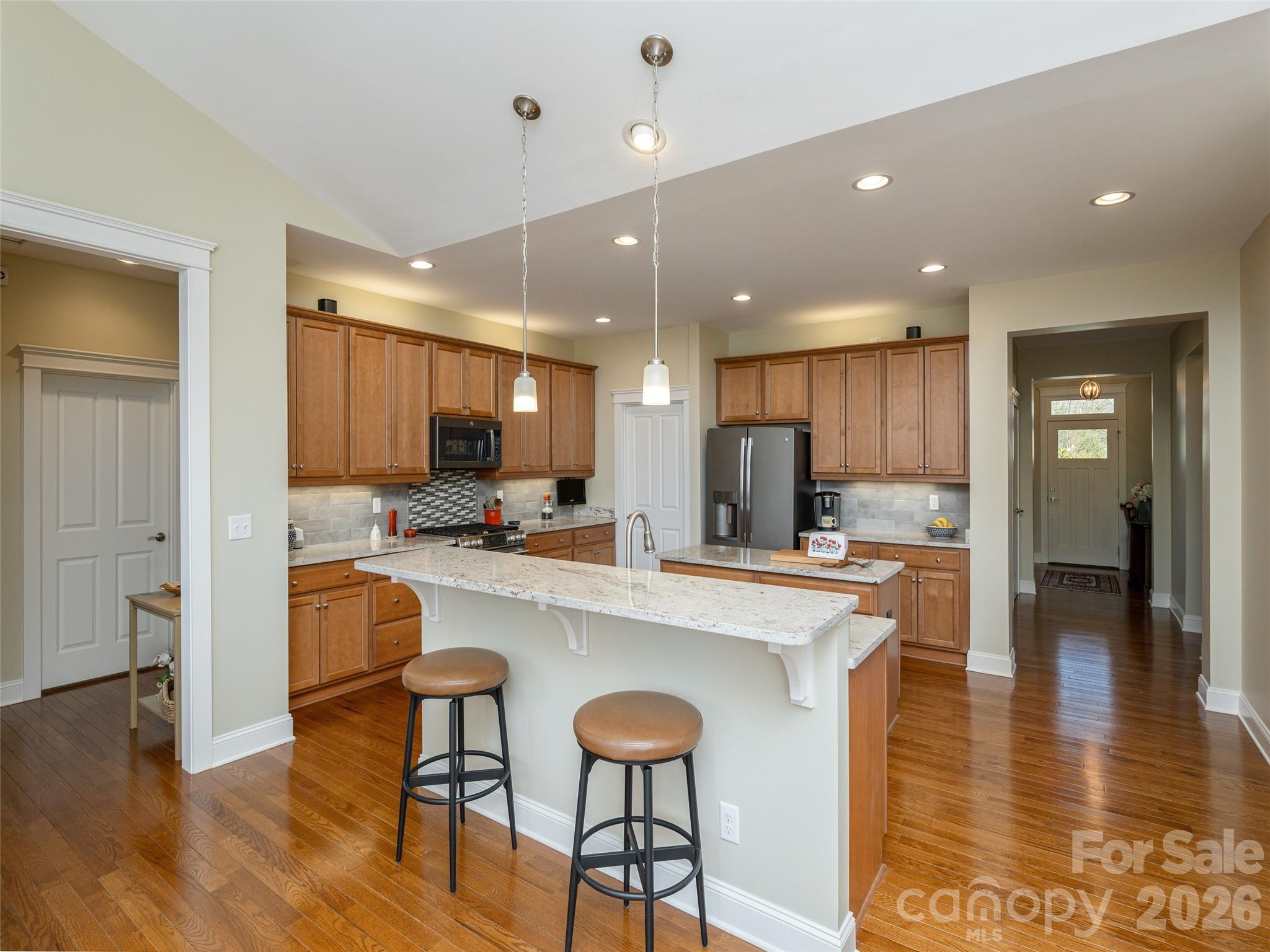 383 Monarch Road Hendersonville, NC 28739 - Photo 18 of 48 a large kitchen with a table and chairs in it