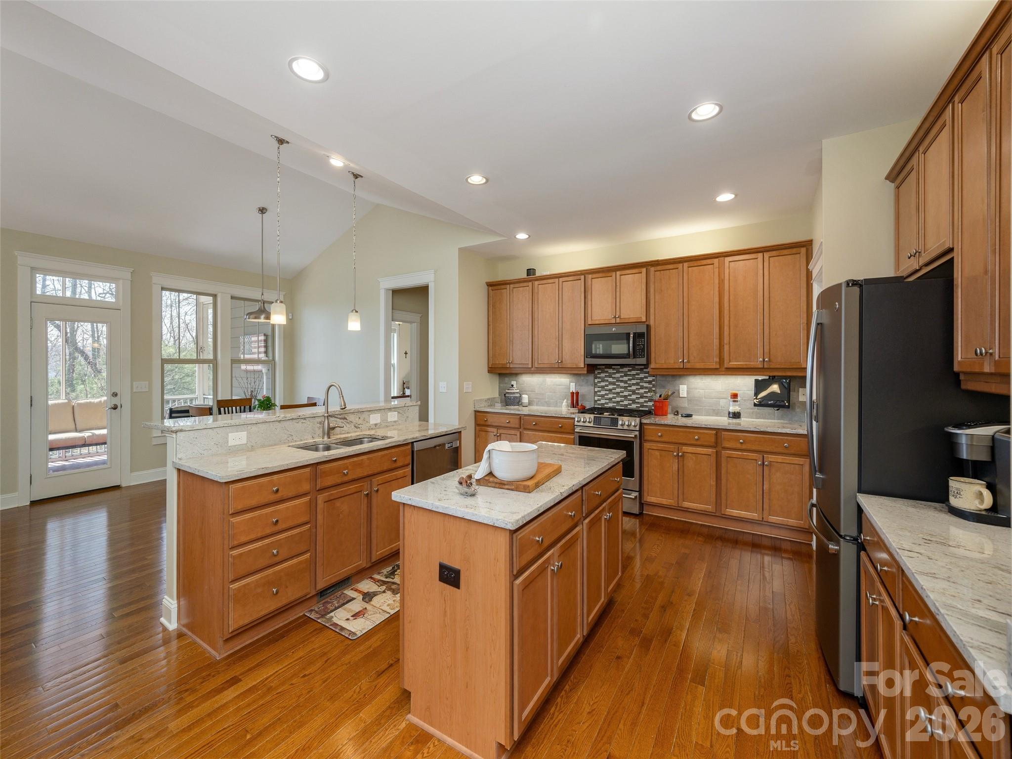 383 Monarch Road Hendersonville, NC 28739 - Photo 19 of 48 a kitchen with granite countertop kitchen island wooden cabinets and stainless steel appliances