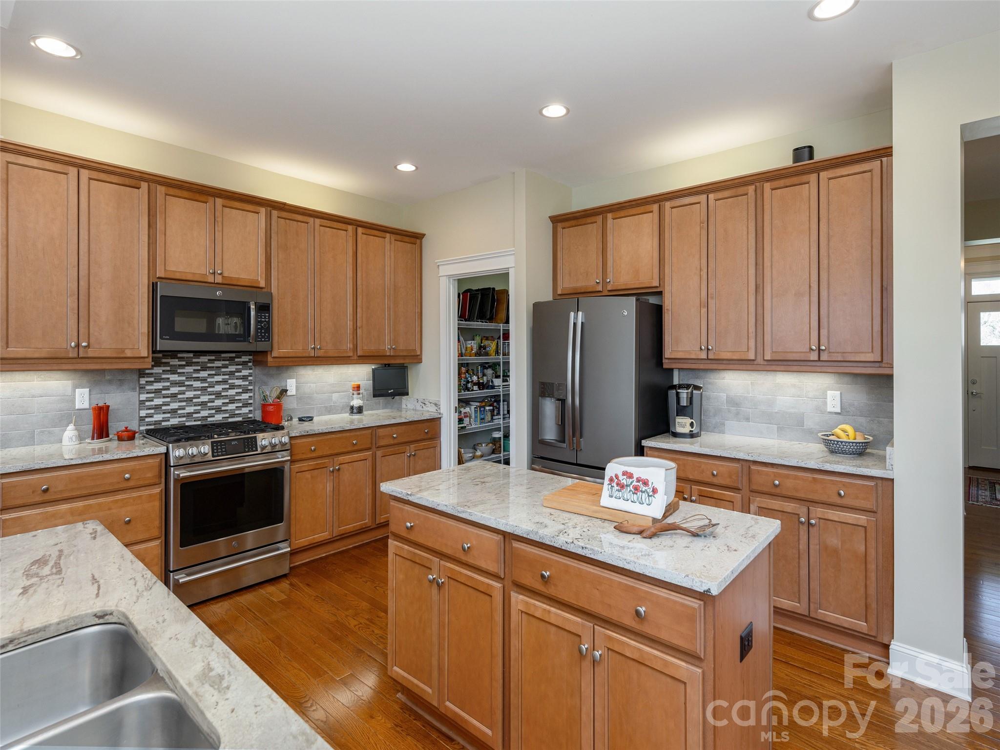 383 Monarch Road Hendersonville, NC 28739 - Photo 21 of 48 a kitchen with stainless steel appliances granite countertop a refrigerator stove microwave sink and cabinets